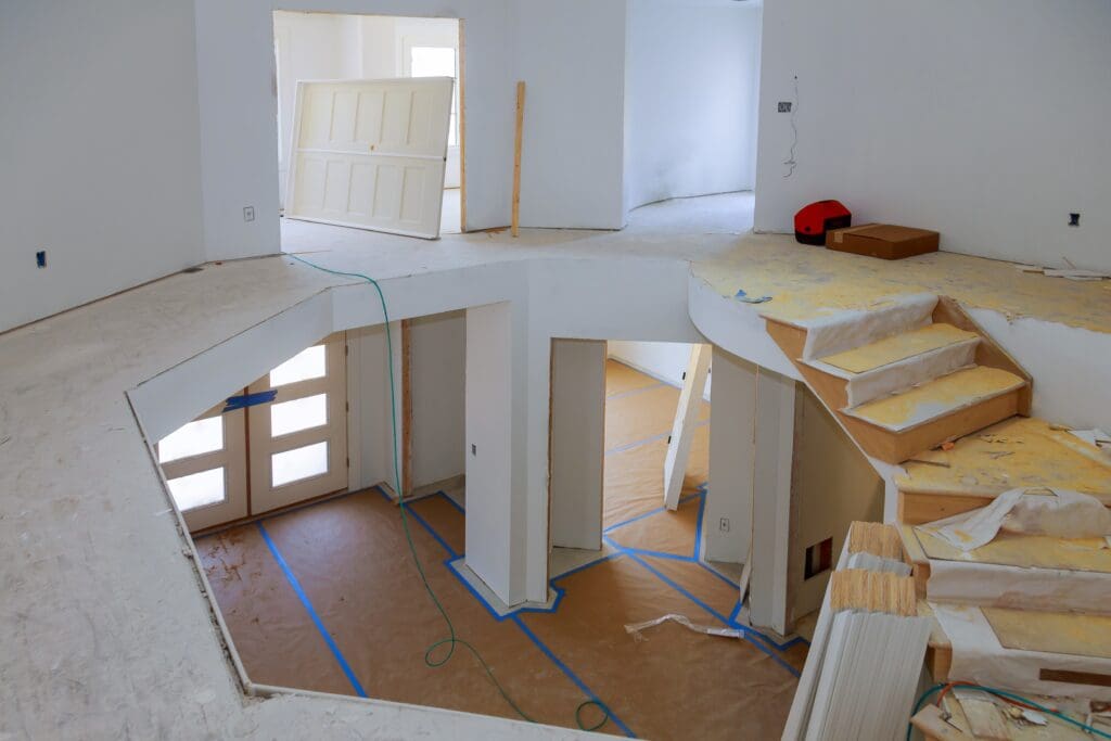 Interior home construction with exposed framing and staircase